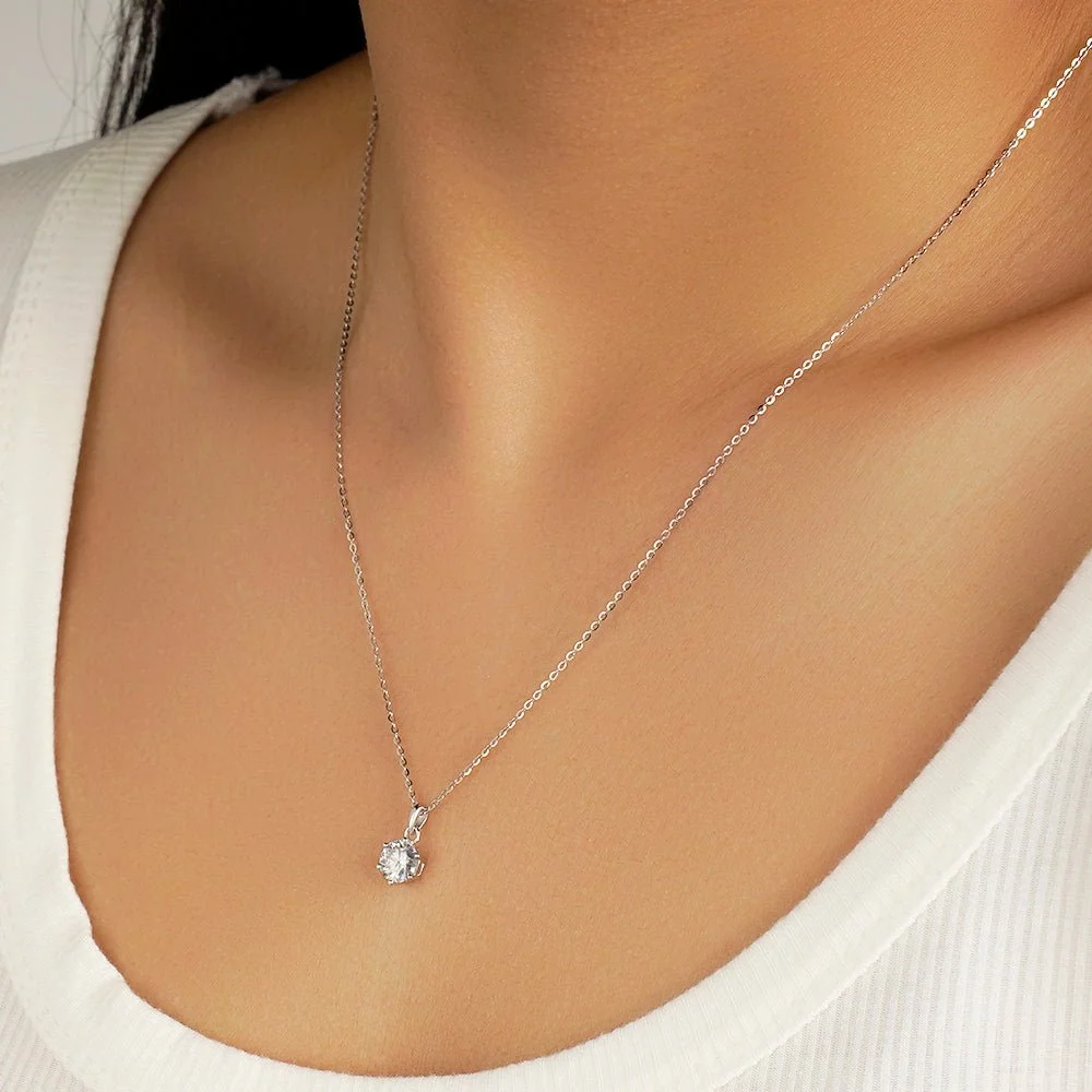 1ct round moissanite pendant necklace on 18 inch silver chain side perspective view on model