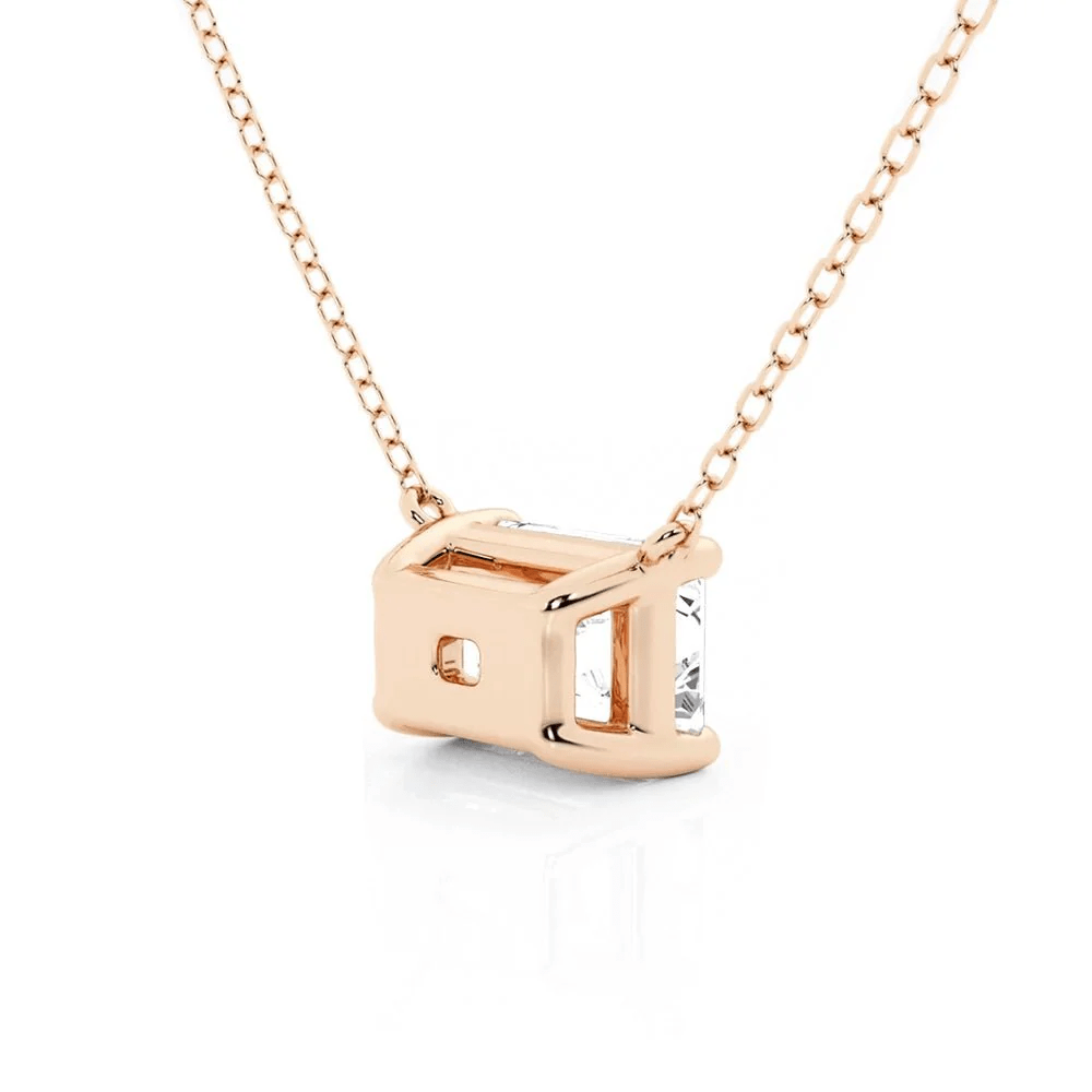 Angled profile view of Horizontal East-West Set Emerald Cut Moissanite Solitaire Necklace in Rose Gold
