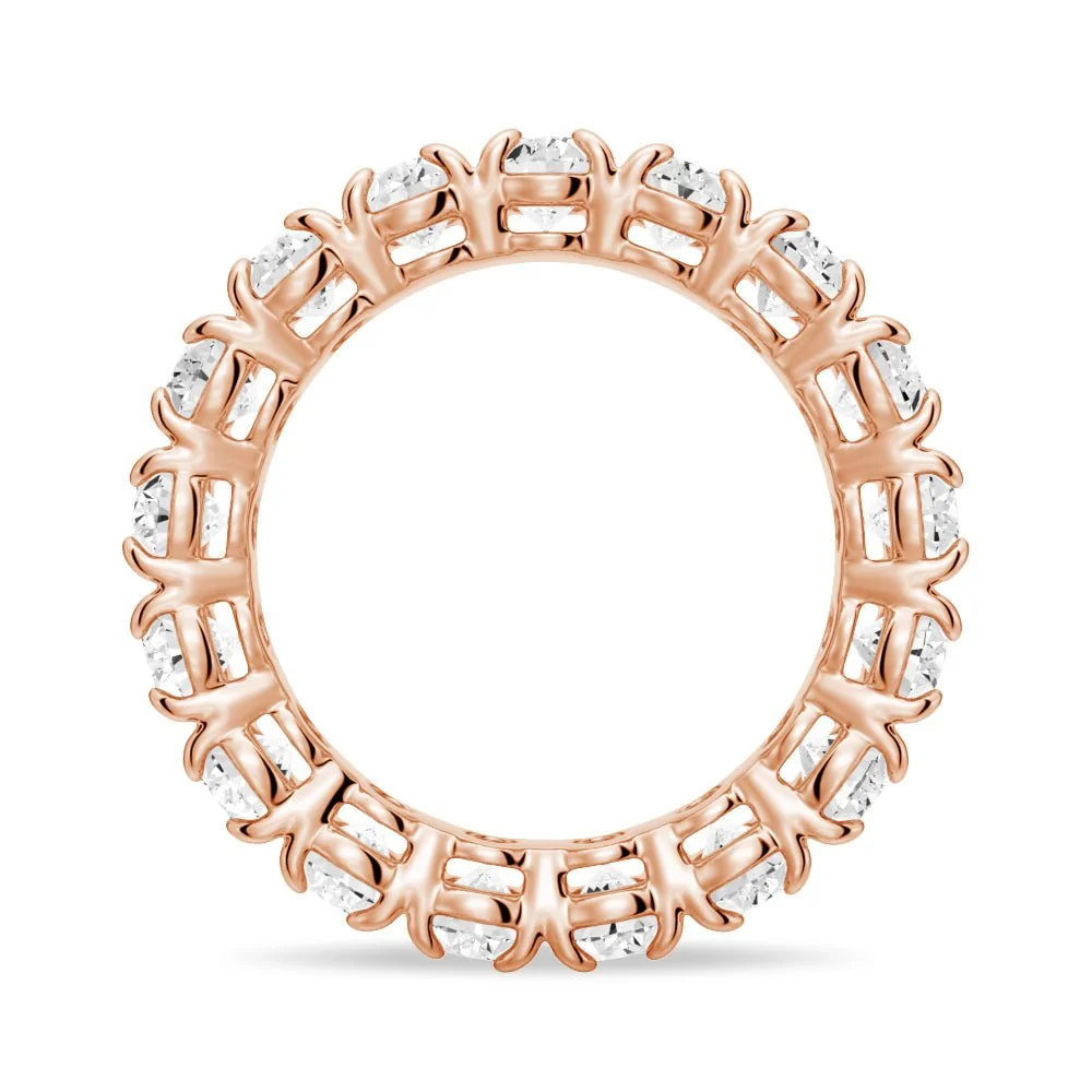 Side circular profile view of rose gold oval cut moissanite eternity ring