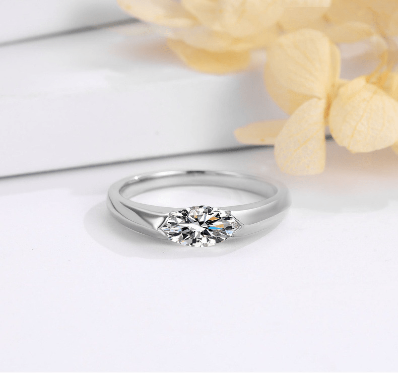 Profile view of East West Marquise Cut Moissanite Ring with Simple Bezel Setting in White Gold