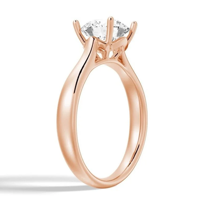 Rose gold round moissanite solitaire engagement ring side profile basket setting