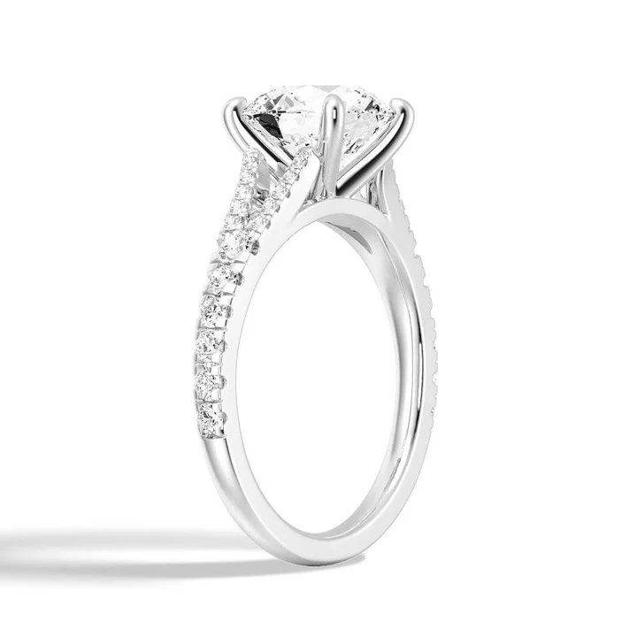 Angled profile view of The Vienna Round Cut Split Shank Moissanite Engagement Ring showing pave detail in White Gold - Novelle Vow