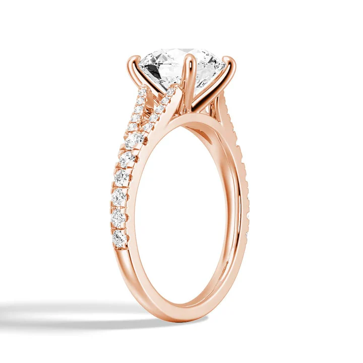 Angled profile view of The Vienna Round Cut Split Shank Moissanite Engagement Ring showing pave detail in Rose Gold