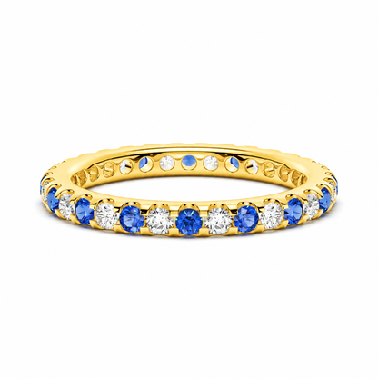 Front view of 2.6mm alternating round blue and white sapphire U-prong eternity band in yellow gold