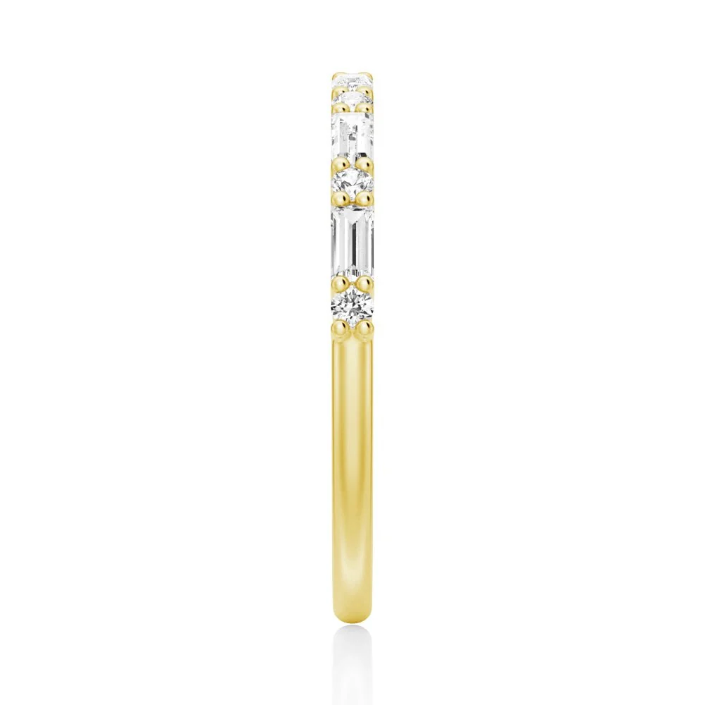 Top view showing 2mm alternating baguette and round moissanite band in yellow gold