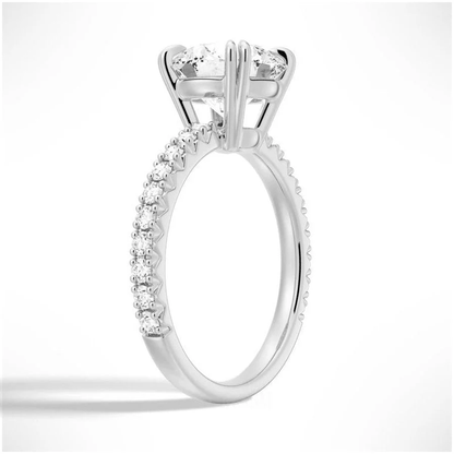 Angled view of Classic Round Moissanite Solitaire Engagement Ring 4 Prong with Pave Band in White Gold - Novelle Vow