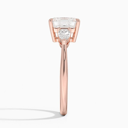 Rose gold classic three-stone asscher cut moissanite engagement ring direct side profile view showing prong set pear accents