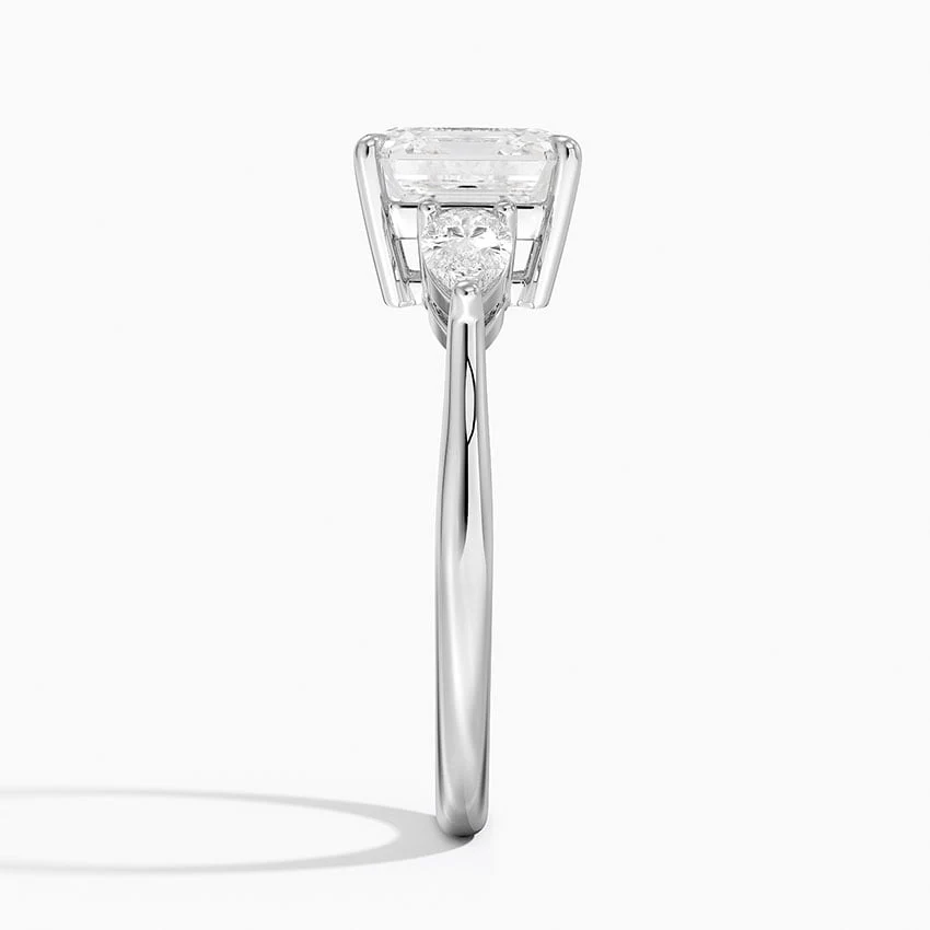 White gold classic three-stone asscher cut moissanite engagement ring direct side profile view showing prong set pear accents
