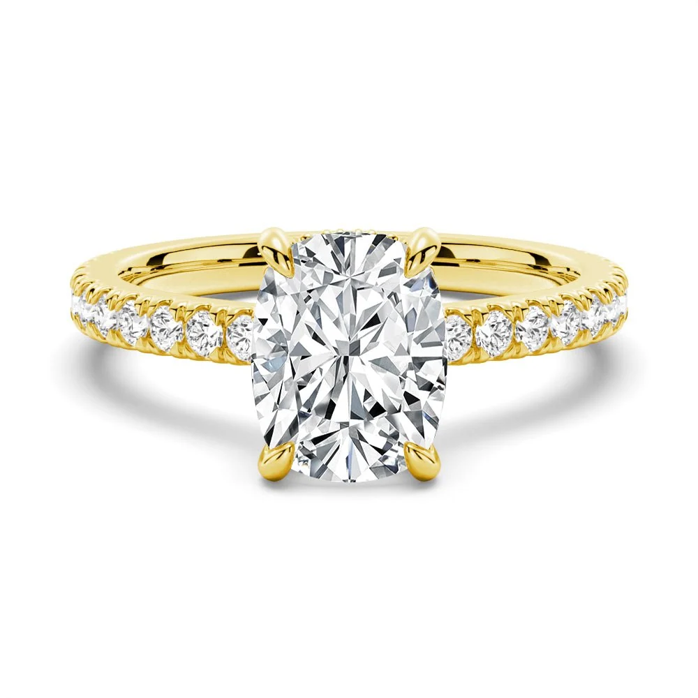 Yellow gold cushion cut moissanite engagement ring top view with pave diamond band