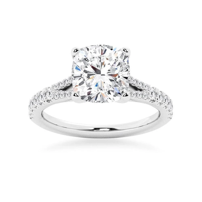 White gold cushion cut moissanite engagement ring top view with split pave shoulders