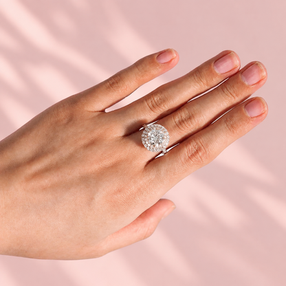 Model hand wearing rose gold double halo round moissanite engagement ring