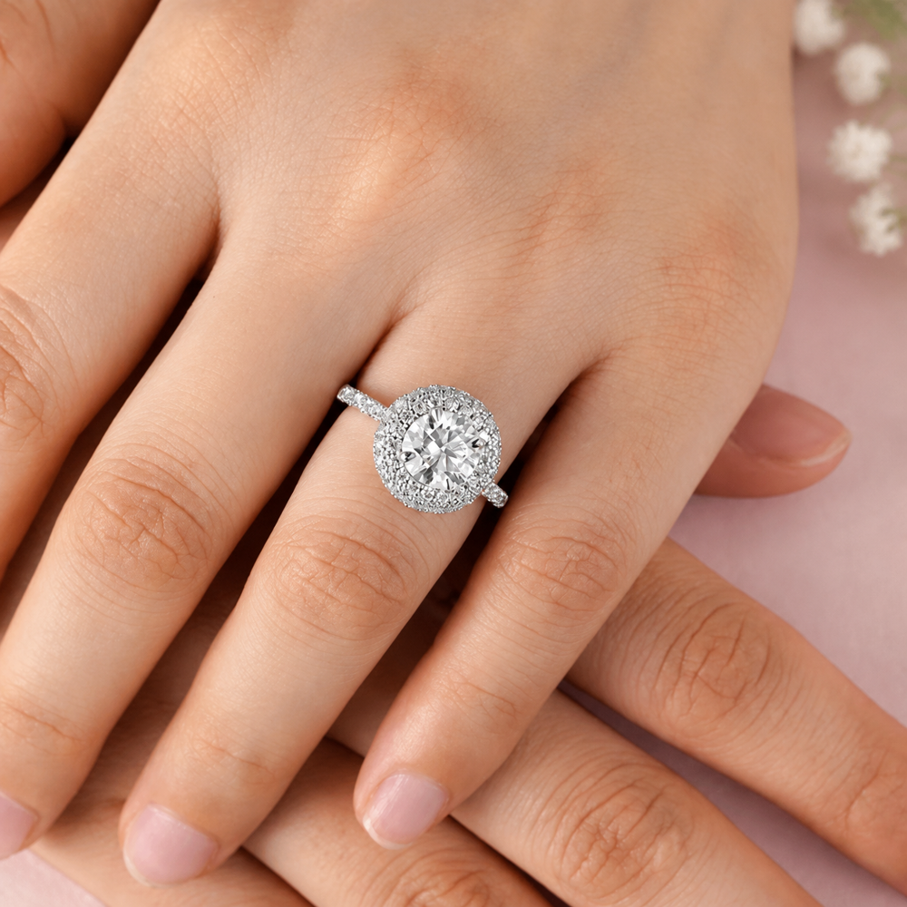 Model hand wearing white gold double halo round moissanite engagement ring