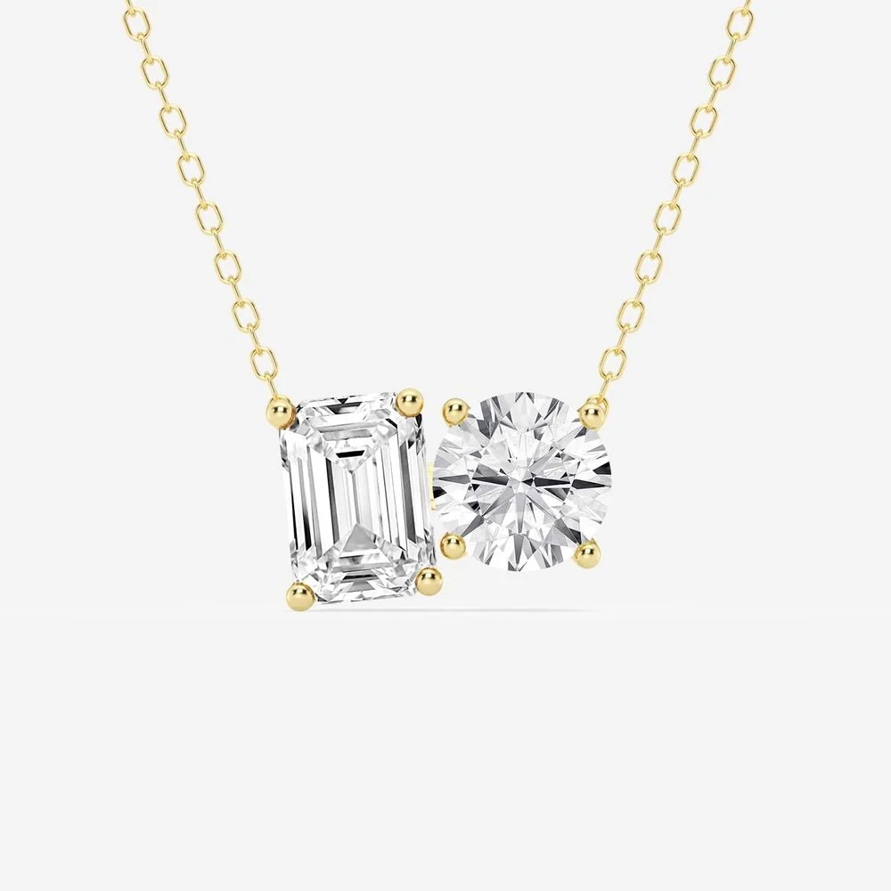 Yellow gold east-west emerald cut and round moissanite two-stone pendant necklace top view