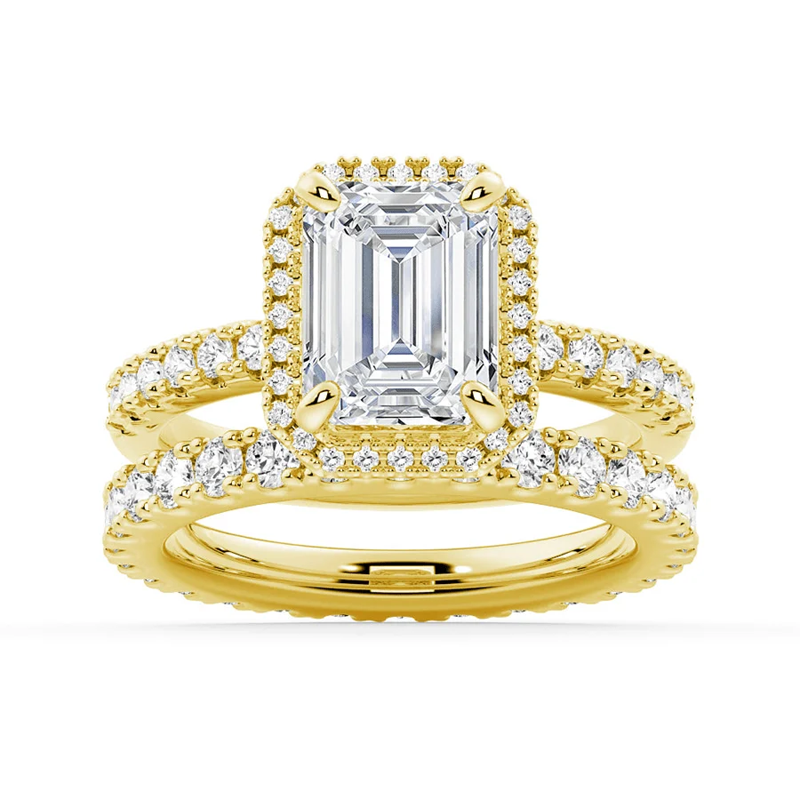 Yellow gold emerald cut moissanite bridal set with halo engagement ring and matching pave wedding band