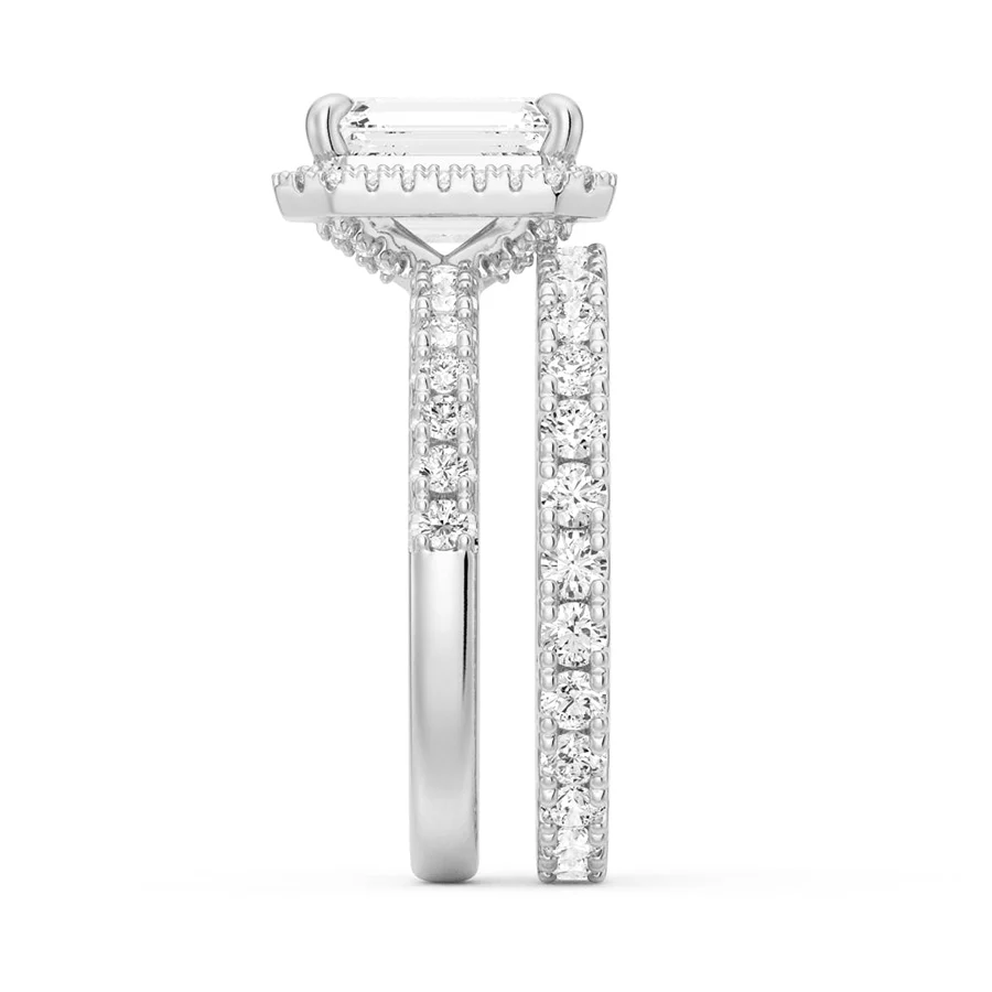 White gold emerald cut moissanite bridal set side profile showing stacked halo basket and pave band