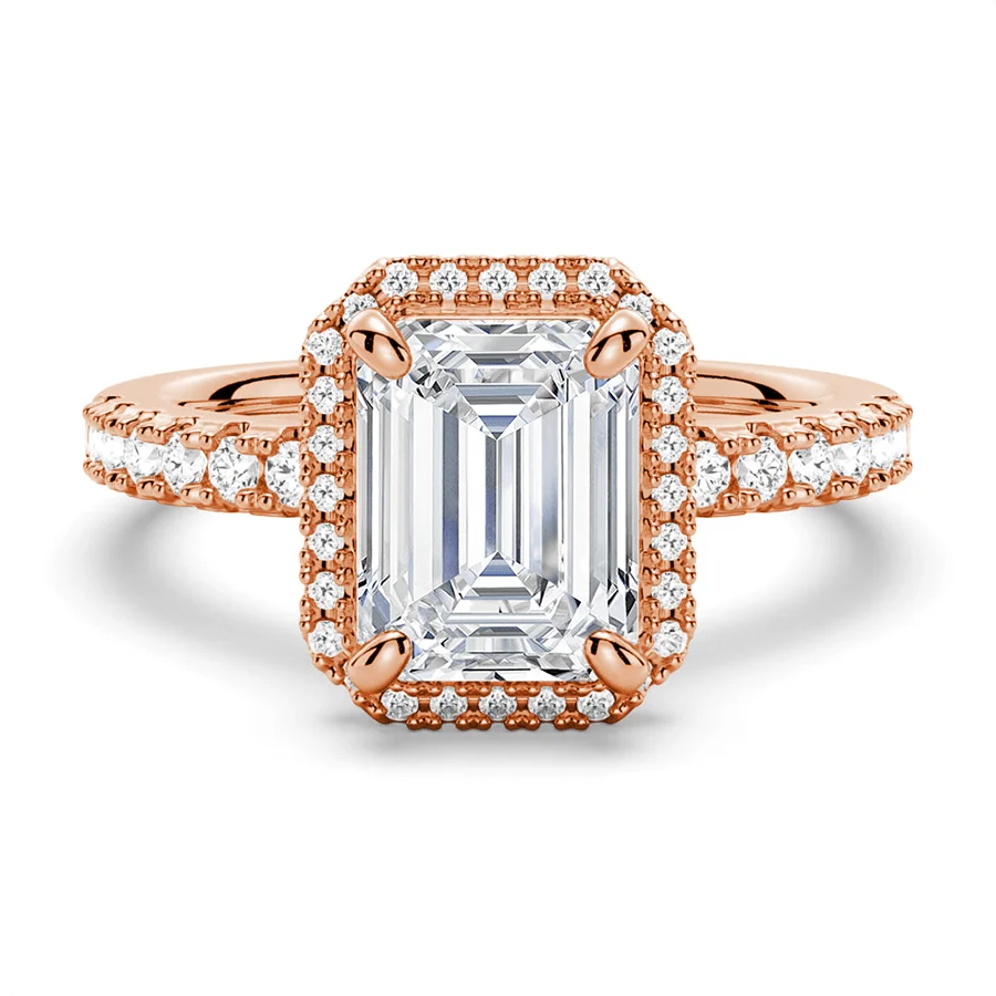 Rose gold emerald cut moissanite engagement ring top view with pave halo and pave band