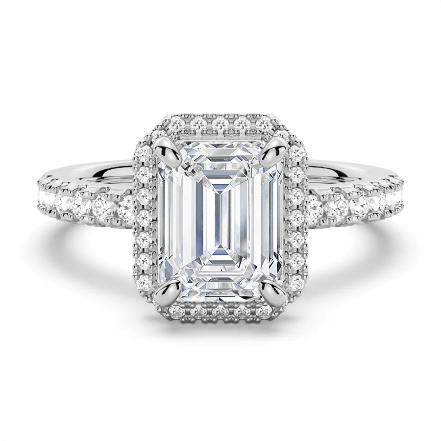 White gold emerald cut moissanite engagement ring top view with pave halo and pave band