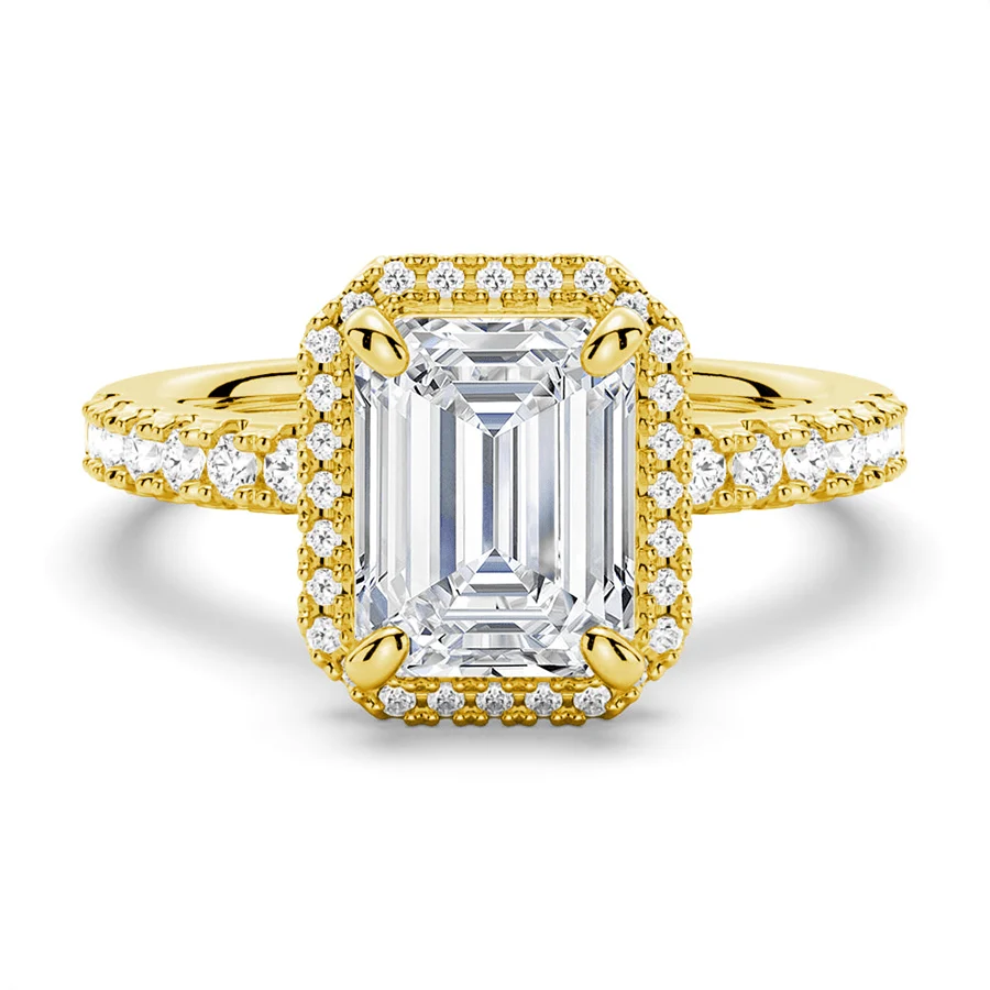 Yellow gold emerald cut moissanite engagement ring top view with pave halo and pave band