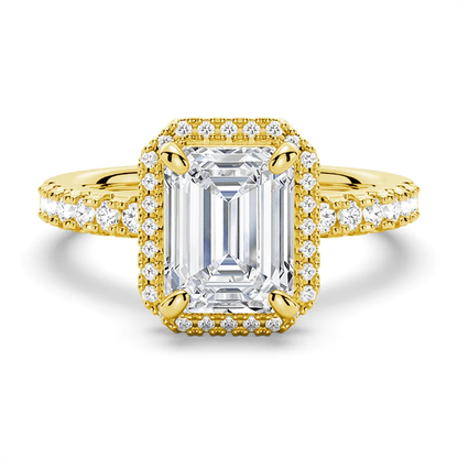 Yellow gold emerald cut moissanite engagement ring top view with pave halo and pave band