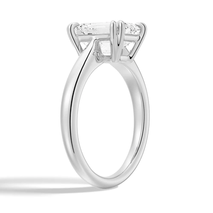 White gold emerald cut moissanite engagement ring 3/4 side low angle perspective view showing plain band