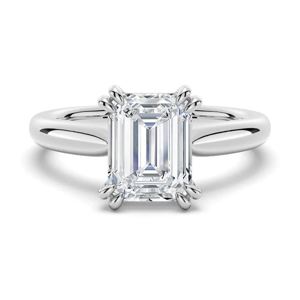 White gold emerald cut moissanite solitaire engagement ring top view showing double claw prongs-Novelle Vow