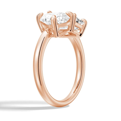 Rose gold emerald and pear cut toi et moi moissanite engagement ring 3/4 perspective view showing prong settings