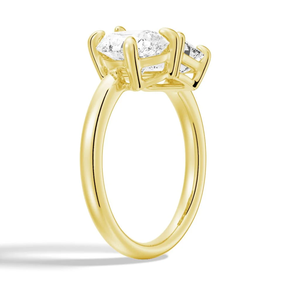 Yellow gold emerald and pear cut toi et moi moissanite engagement ring 3/4 perspective view showing prong settings