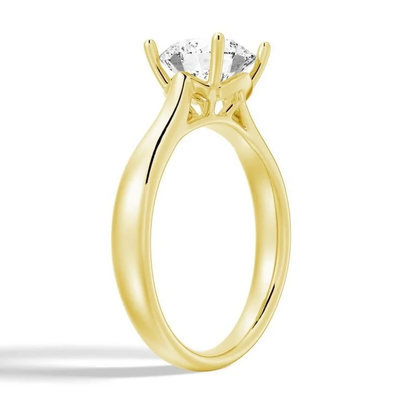 Yellow gold round moissanite solitaire ring side profile showing prong detail