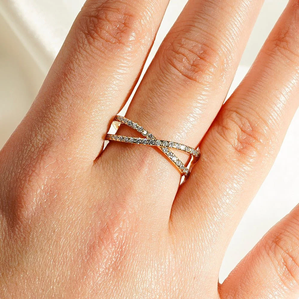 Full profile view of French pave moissanite crossover wedding band in yellow gold color