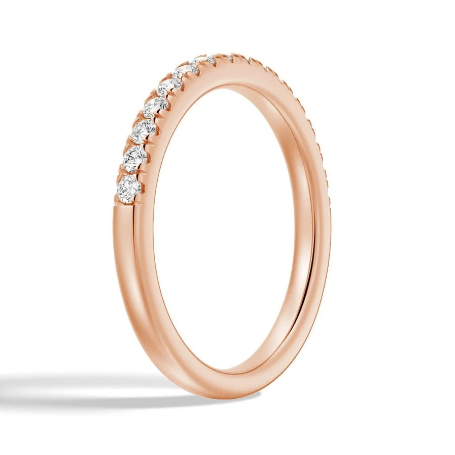 Three quarter perspective view of rose gold French pave moissanite ring