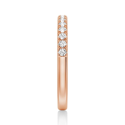 Side profile view showing pave set moissanite stones on rose gold band