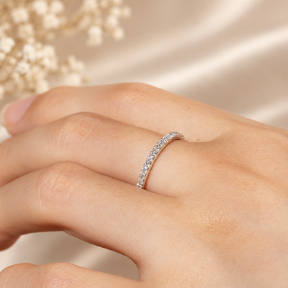 On-finger lifestyle view of 1.4mm white gold French pave moissanite wedding band