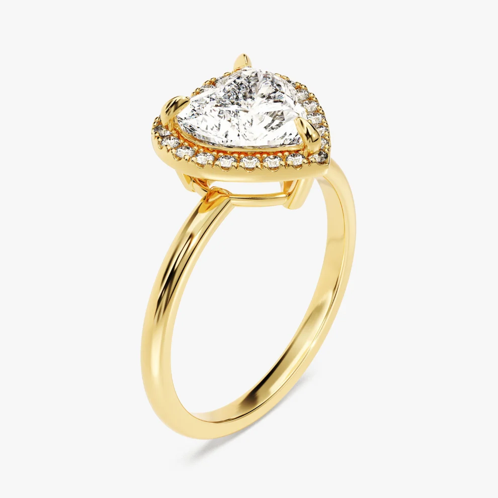 Yellow gold heart shaped moissanite halo engagement ring 3/4 side low angle perspective view showing basket