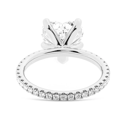 White gold heart shaped moissanite engagement ring side profile perspective view showing three prong basket