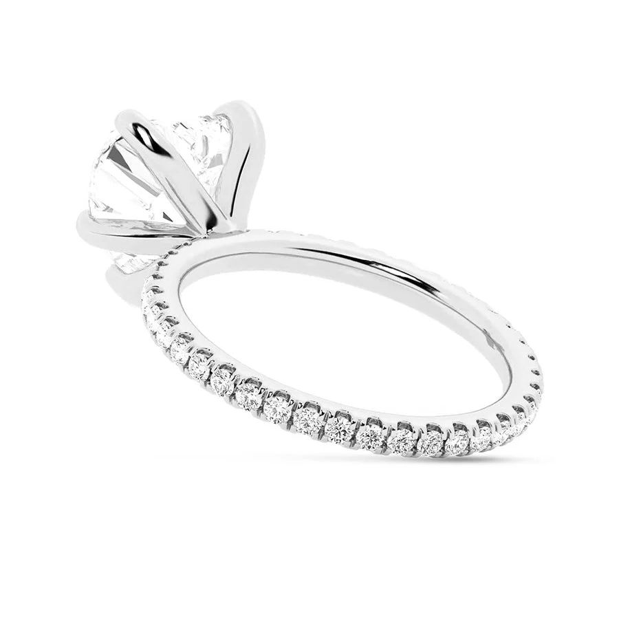 White gold heart shaped moissanite engagement ring direct side view showing pave band
