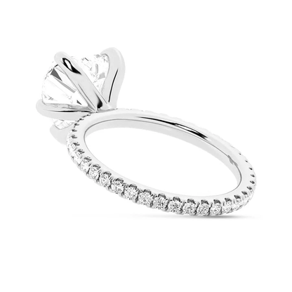 White gold heart shaped moissanite engagement ring direct side view showing pave band