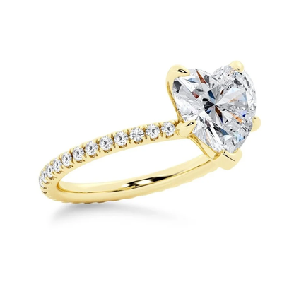 Yellow gold heart shaped moissanite engagement ring tilted perspective view with pave diamond band
