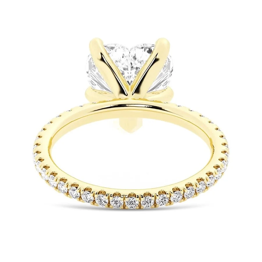 Yellow gold heart shaped moissanite engagement ring side profile perspective view showing three prong basket
