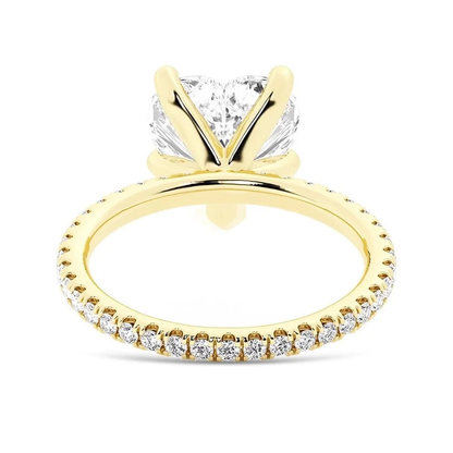 Yellow gold heart shaped moissanite engagement ring side profile perspective view showing three prong basket