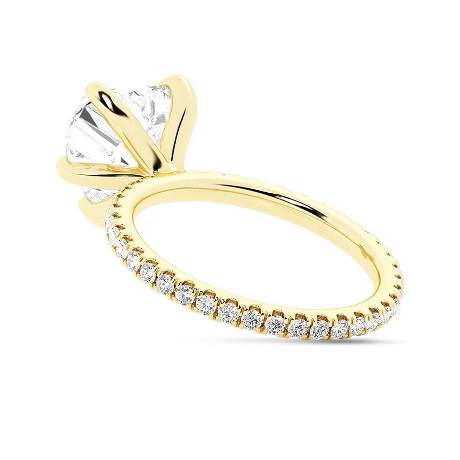 Yellow gold heart shaped moissanite engagement ring direct side view showing pave band
