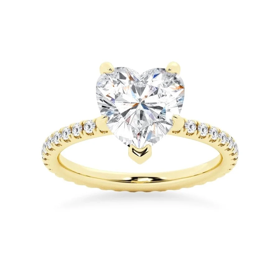 Yellow gold heart shaped moissanite engagement ring side profile perspective view showing three prong basket