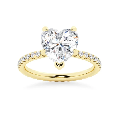 Yellow gold heart shaped moissanite engagement ring side profile perspective view showing three prong basket