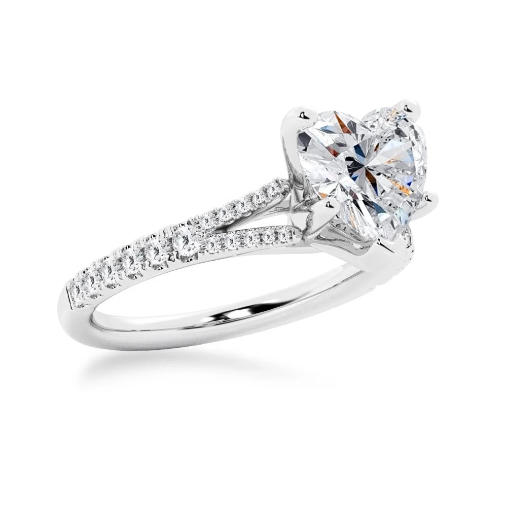 White gold heart shaped moissanite engagement ring 3/4 side perspective view showing pave split shank