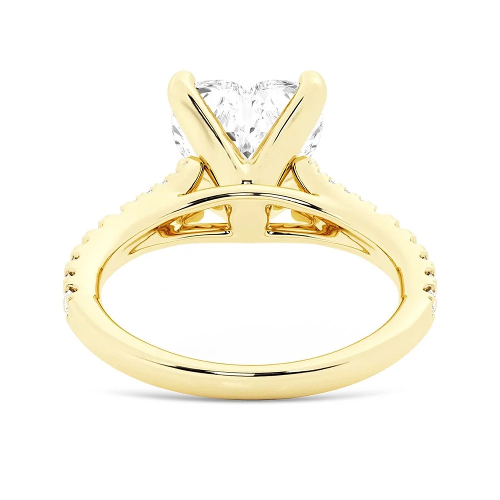 Yellow gold heart shaped moissanite engagement ring side profile view showing split shank basket