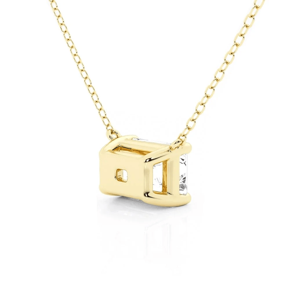 Angled profile view of Horizontal East-West Set Emerald Cut Moissanite Solitaire Necklace in Yellow Gold