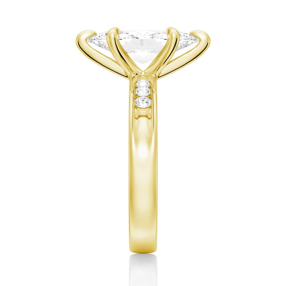 Yellow gold marquise cut moissanite engagement ring direct side view showing channel set accents