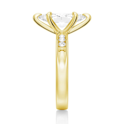 Yellow gold marquise cut moissanite engagement ring direct side view showing channel set accents