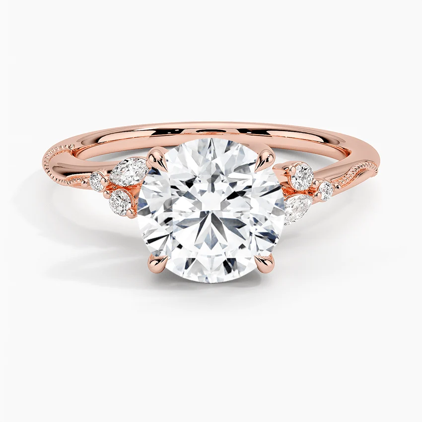 Front view of rose gold round moissanite solitaire ring with marquise and round side accents