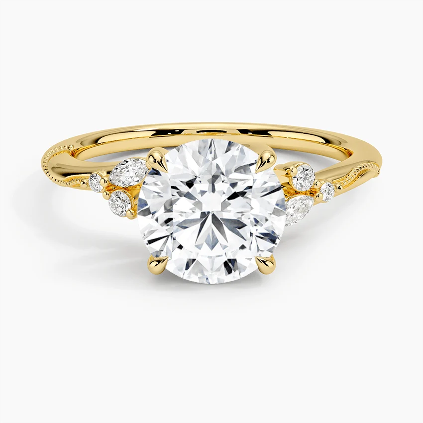 Front view of yellow gold round moissanite engagement ring featuring marquise side stones