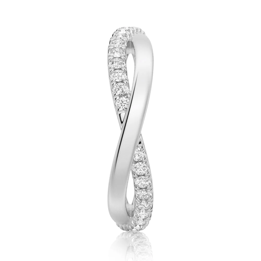 Top view showing 4.3mm infinity crossover pave moissanite band structure in white gold